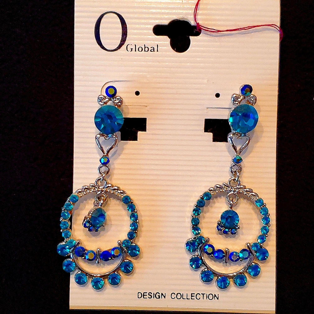 Earrings with greenish blue rhinestones with silver accents.